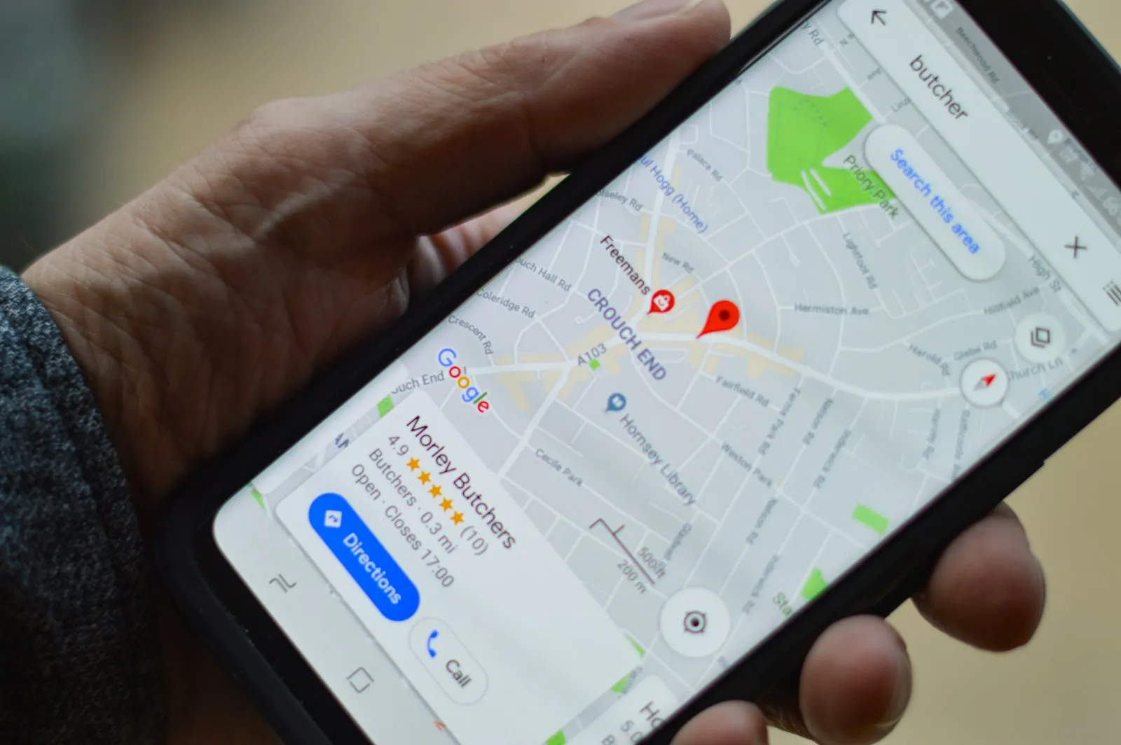Smartphone showing Google Maps business listing in Vietnam