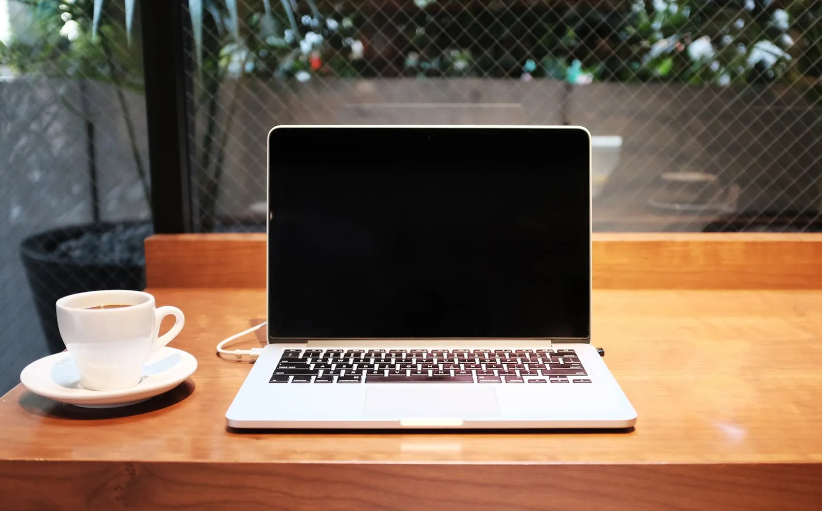 Laptop and coffee — writing a Naver Blog review for a tourism business